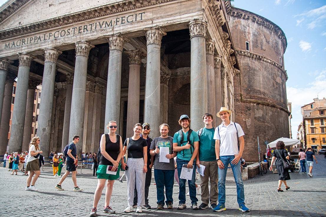 People posing for a photo in front of the Pantheon in Rome