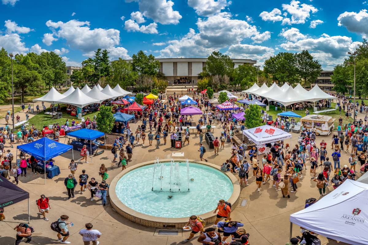 People at an event with a fountain in the middle