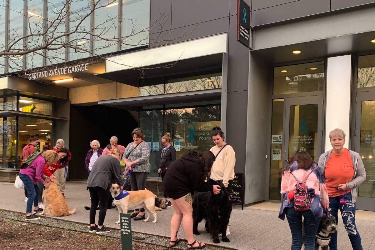People gathered on a sidewalk in front of a building